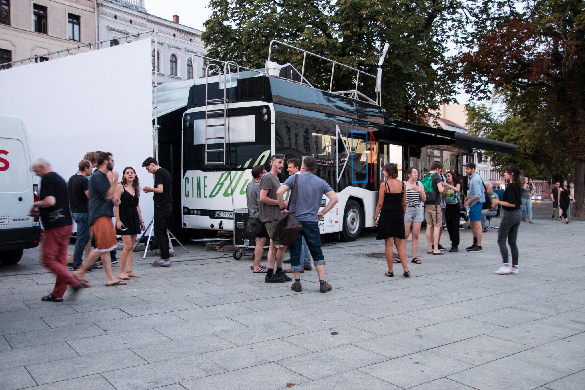Cinebus zaparkowany na rynku w Goerlitz na pierwszym planie uczestnicy kursu audiowizualnego.